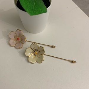 Hand crafted and painted ceramic flower stick pins by local artist Julie Moon.